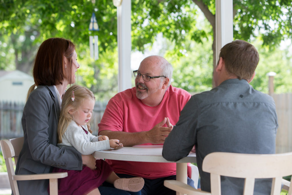 Family smiling and unpacking healthy groceries